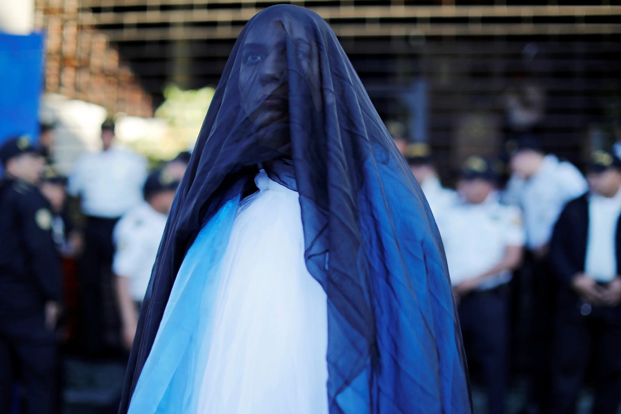 Demonstrators take part in a march to protest against the decision of Guatemala President Jimmy Morales to end the mandate of the UN-backed anti-graft commission (CICIG), in Guatemala City.