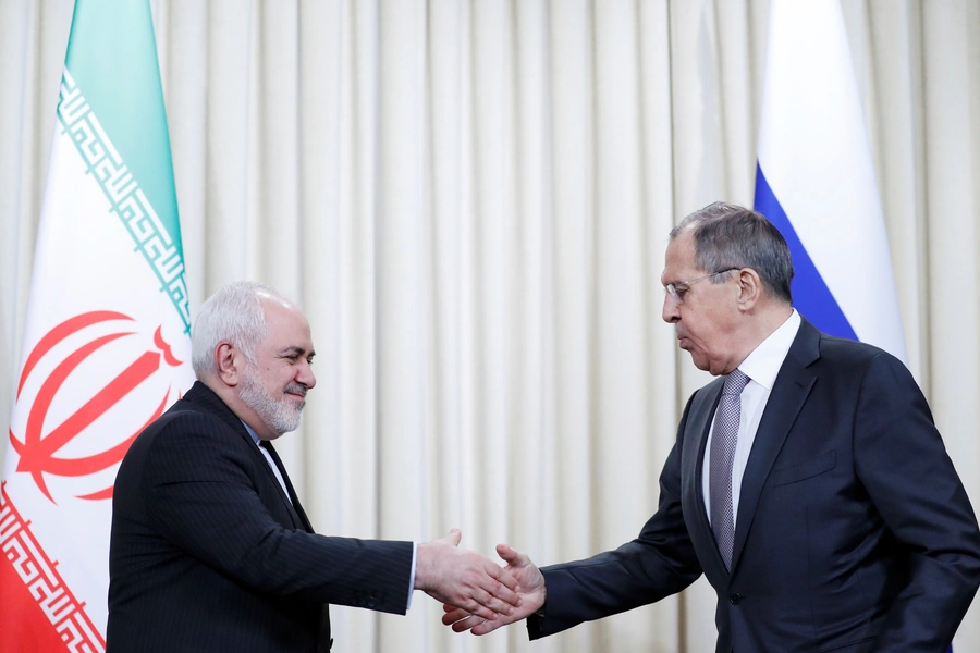 Iran's Foreign Minister Mohammad Javad Zarif shakes hands with Russia's Foreign Minister Sergei Lavrov.