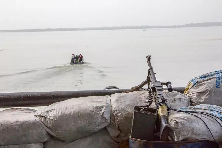A machine gun is seen on a sandbag on a boat off the Atlantic coast in Nigeria's Bayelsa State on December 19, 2013.