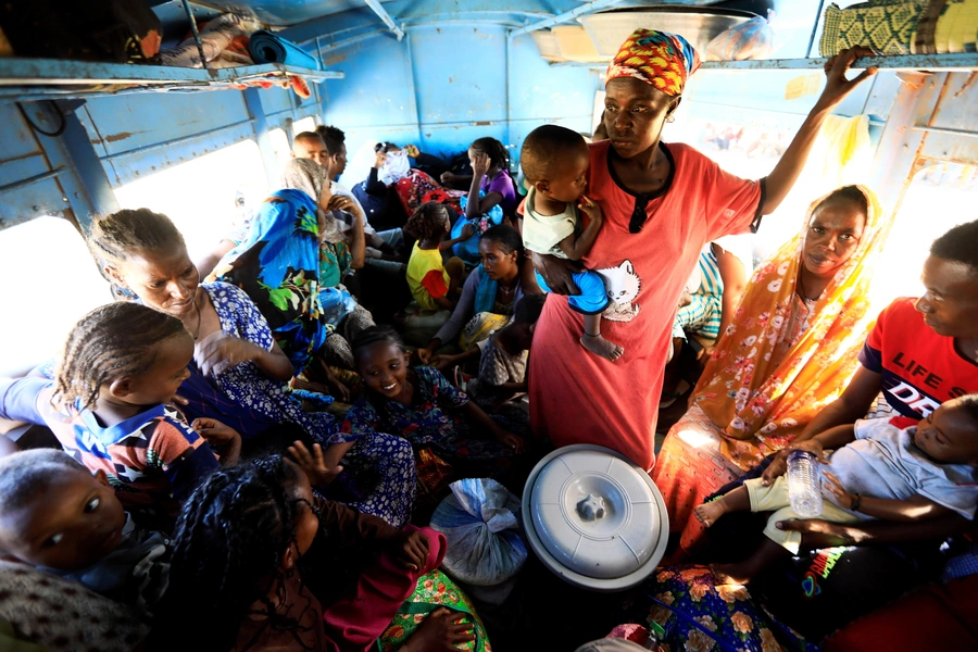 Ethiopian refugees who fled Tigray region, sit inside a courtesy bus at the Fashaga camp as they are transferred to Um-Rakoba camp on the Sudan-Ethiopia border, in Kassala state, Sudan December 13, 2020.