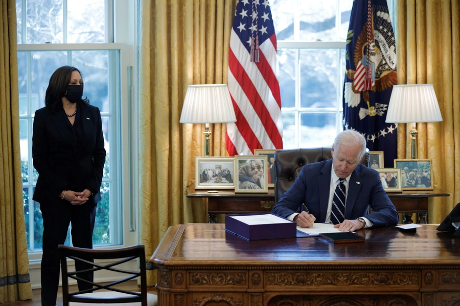 President Joe Biden signs the American Rescue Plan on March 11 (accompanied by Vice President Kamala Harris).