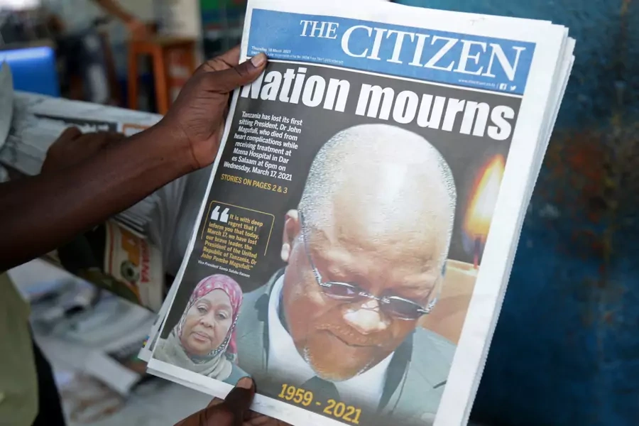 A man holds a newspapers following the death of Tanzania's President John Magufuli in Dar es Salaam, Tanzania on March 18, 2021.