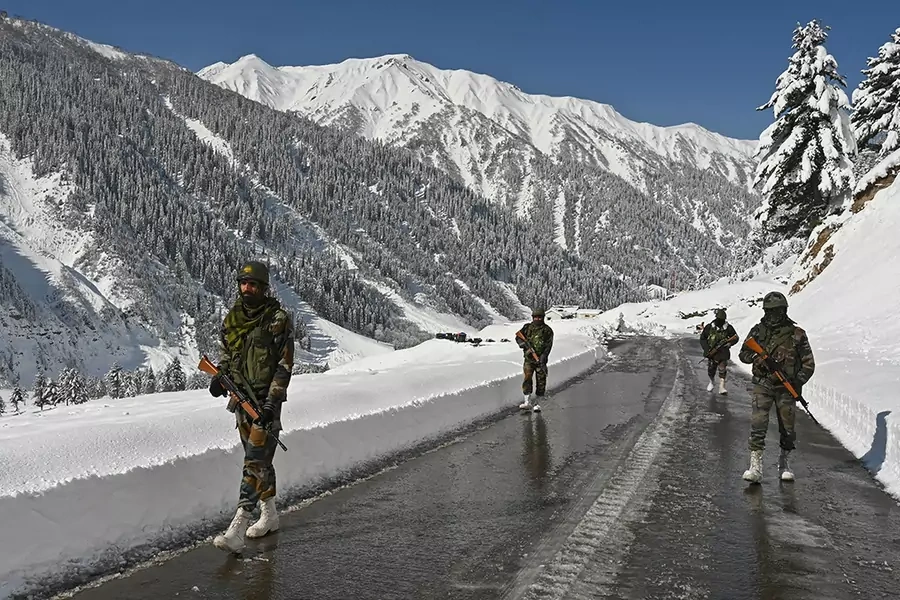 Indian army soldiers walk along a road near Zojila mountain pass that connects Srinagar to the union territory of Ladakh, bordering China, on February 28, 2021.