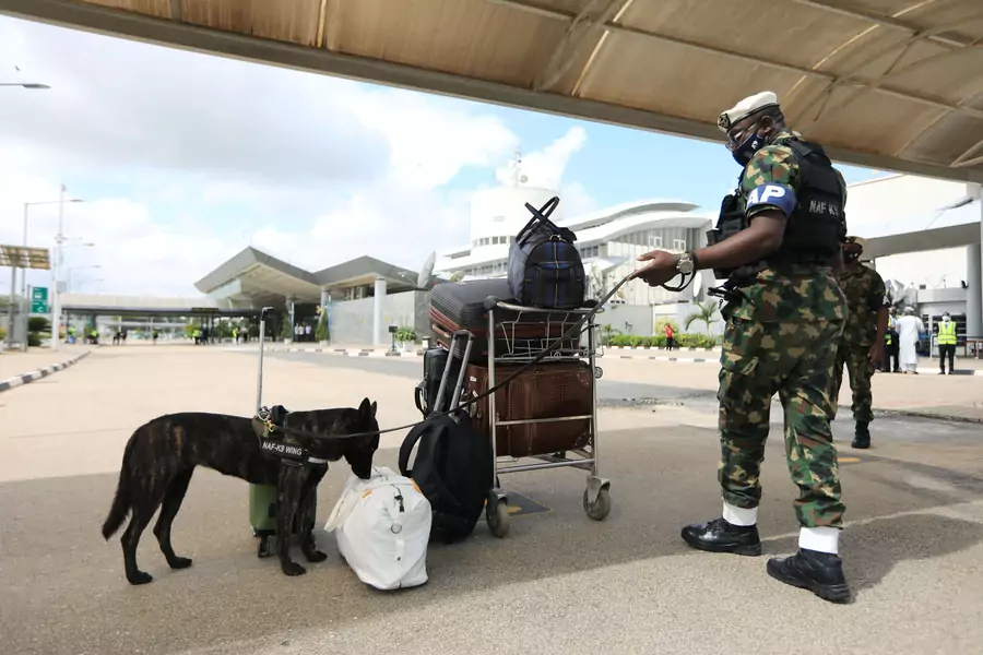 A Nigerian Air Force dog sniffs a bag at the domestic wing of the Nnamdi Azikiwe International Airport in Abuja, Nigeria on July 8, 2020.