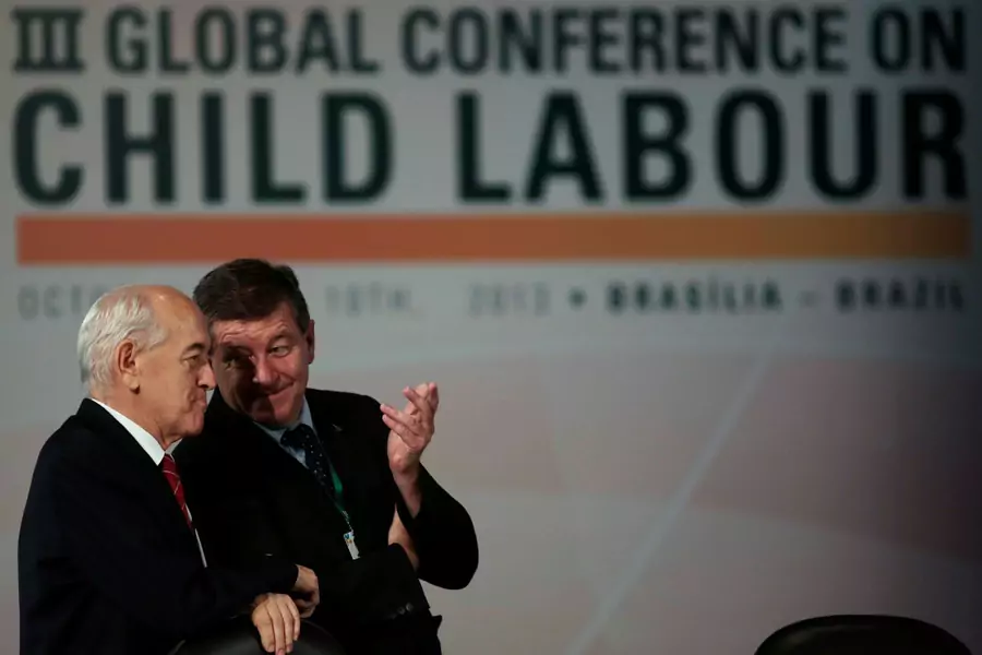 Guy Ryder, director-general of the International Labor Organization, talks to Manoel Dias, former Brazilian minister of labor, at the Third Global Conference on Child Labor in Brazil.