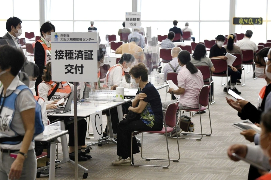 Senior citizens wait to receive a coronavirus disease (COVID-19) vaccine at a large-scale coronavirus disease (COVID-19) vaccination centre in Osaka, western Japan May 24, 2021, in this photo distributed by Kyodo