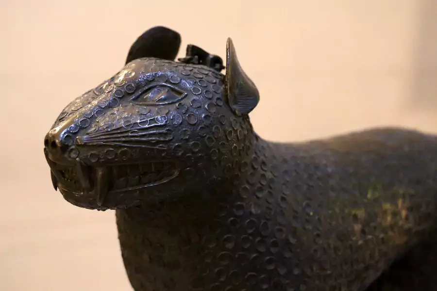 A close-up photo of a Benin Bronze resembling a leopard on display in the Bode-Museum in Berlin, Germany.