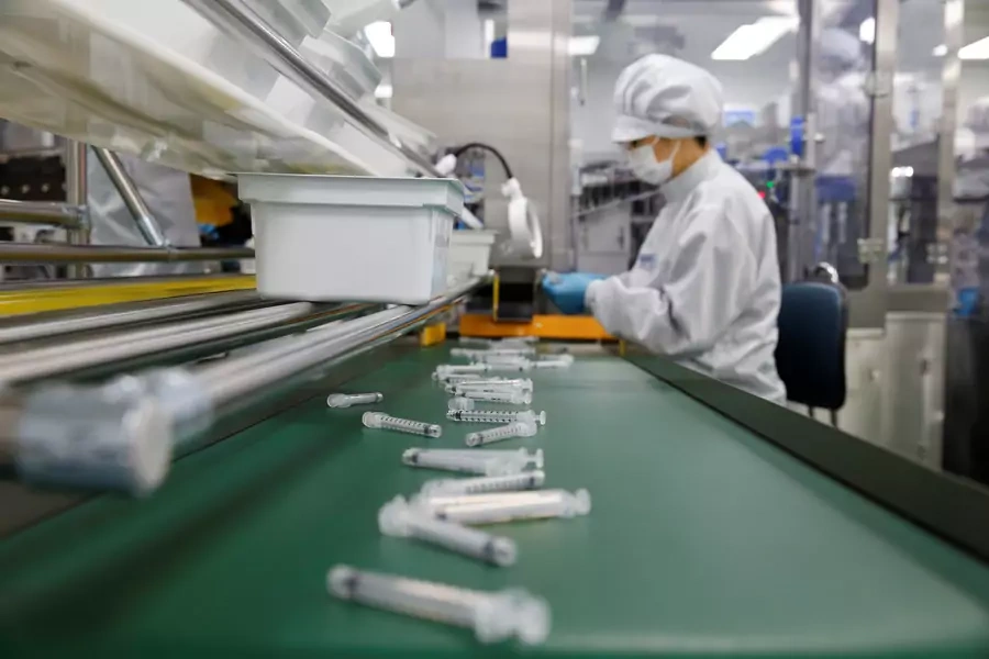 An employee works at a syringe factory in Gunsan, South Korea, on April 5, 2021. 