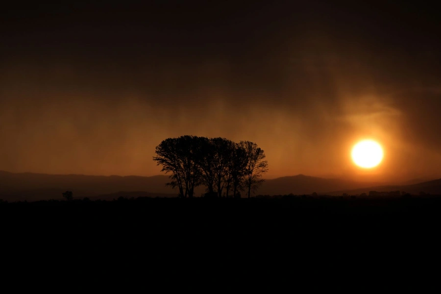 Rain clouds are lit by the setting sun near the village of Chernogorovo, Bulgaria on July 3, 2019. 