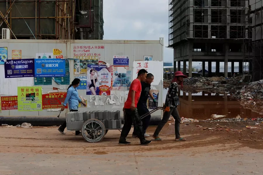 Construction workers move cement blocks in Chinatown, Sihanoukville, Cambodia, on May 18, 2019.