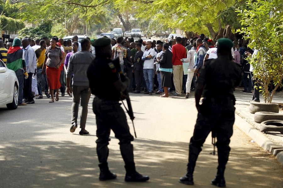 Policemen stand guard as supporters of Indigenous People of Biafra (IPOB) leader Nnamdi Kanu take in a rally as he is expected to appear at a magistrate court in Abuja, Nigeria on December 1, 2015.