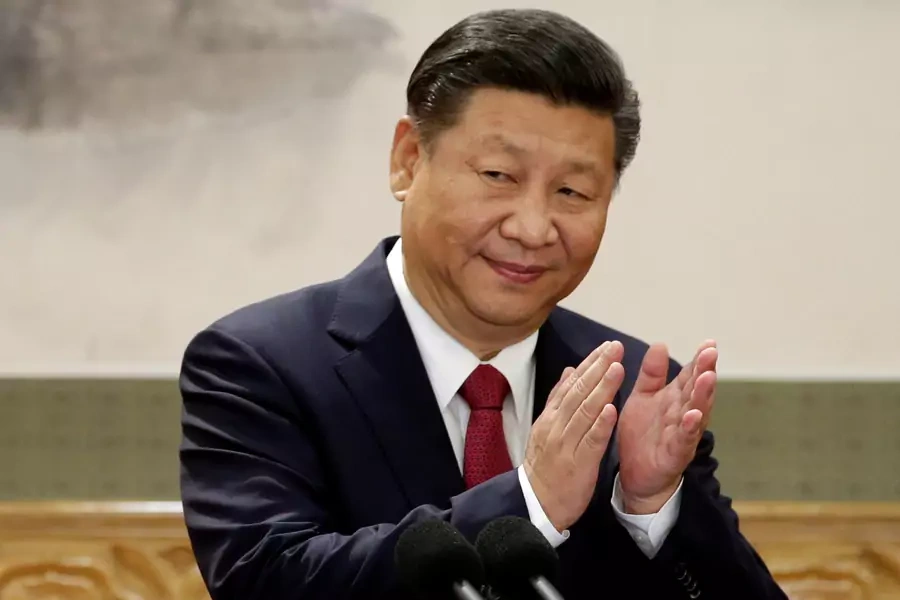 China's President Xi Jinping claps after his speech.