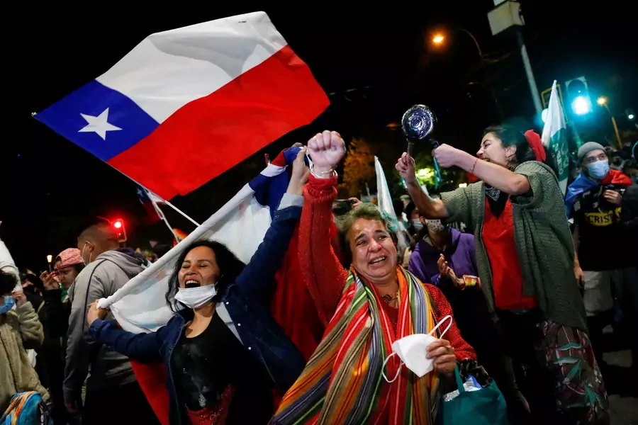 Women in Valaparaiso, Chile celebrate the approval of a national referendum authorizing a rewrite of the nation's constitution.