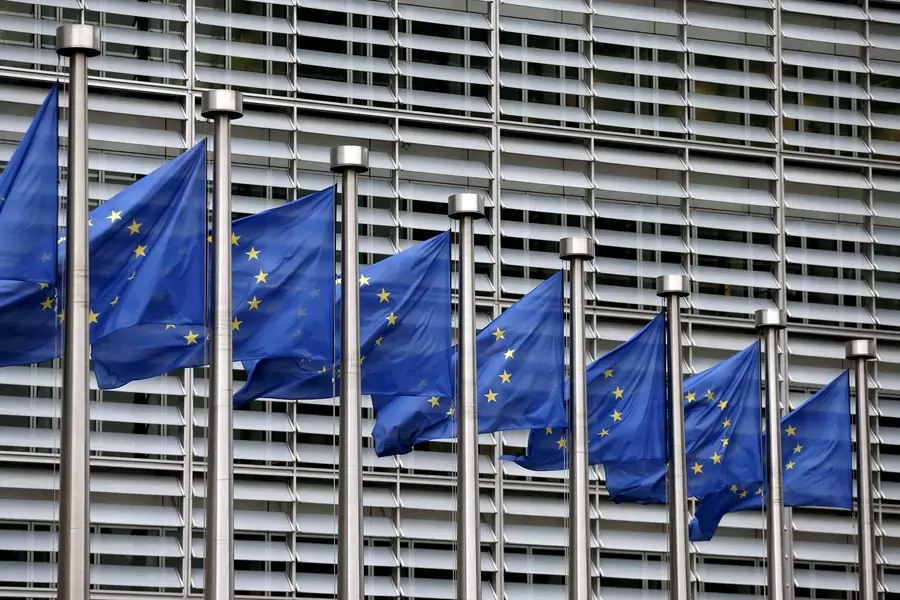 European Union flags flutter outside the EU Commission headquarters in Brussels, Belgium.