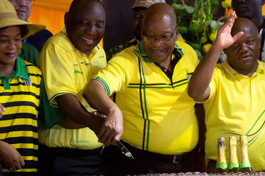 South African President Cyril Ramaphosa and former President Jacob Zuma cut a cake celebrating the 107th anniversary of the African National Congress in Durban, South Africa on January 8, 2019.