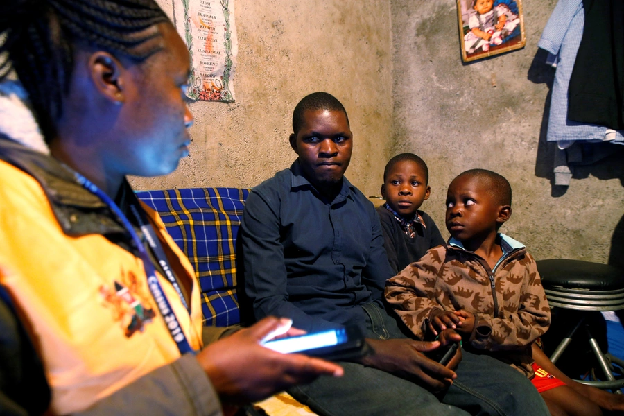 An enumerator uses a census laptop to record details of a family participating in the 2019 Kenya Population and Housing Census at the Kibera slum in Nairobi, Kenya on August 24, 2019.