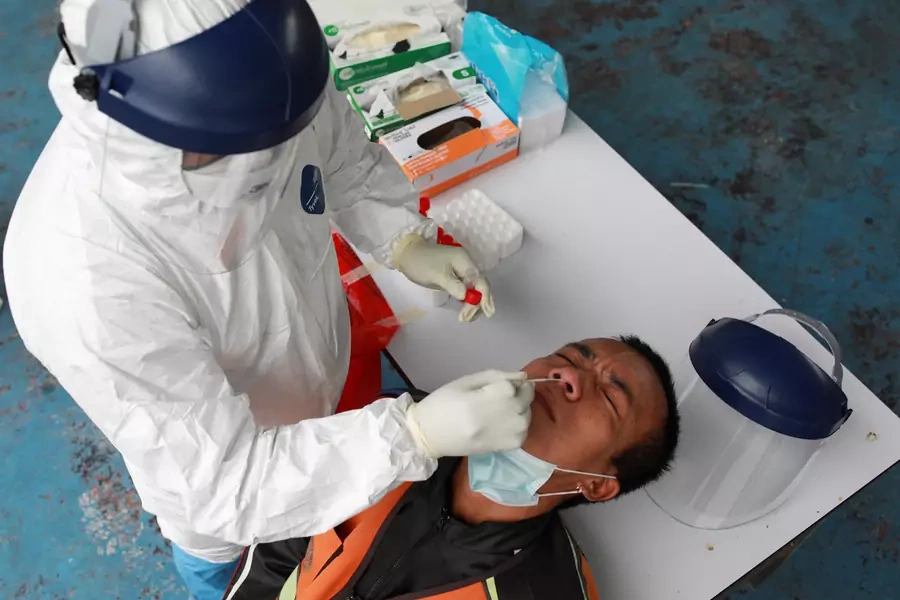A health worker takes a nasal swab sample from a man in Bangkok on May 4, 2021.