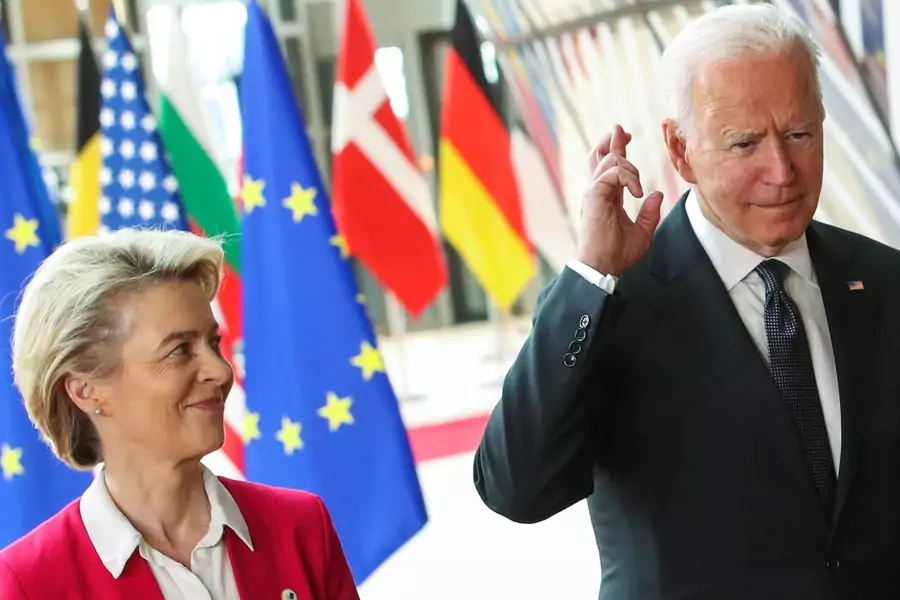 U.S. President Joe Biden crosses his fingers next to European Commission President Ursula von der Leyen as they attend the EU-US summit, in Brussels, Belgium June 15, 2021.