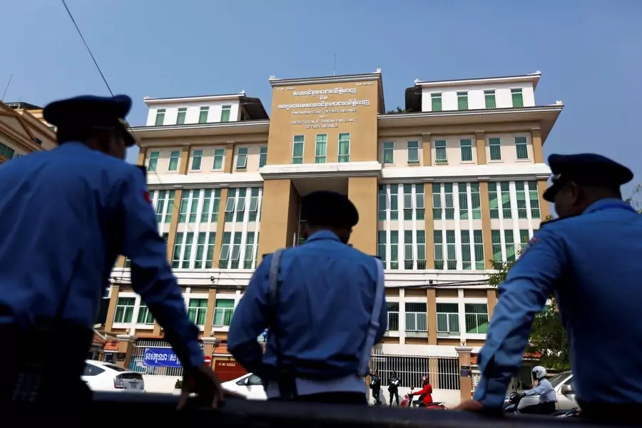 Police officers stand in front of the municipal courthouse in Phnom Penh. Cambodia has made recent strides in convicting traffickers.