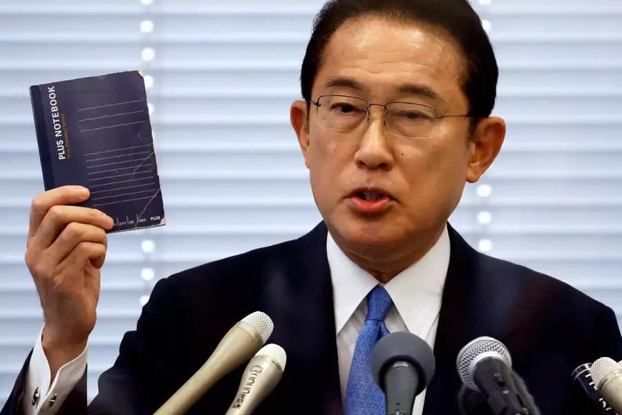 Fumio Kishida, Japan's ruling Liberal Democratic Party (LDP) lawmaker and former foreign minister, shows his notebook during a news conference as he announces his candidacy for the party's presidential election in Tokyo, Japan August 26, 2021