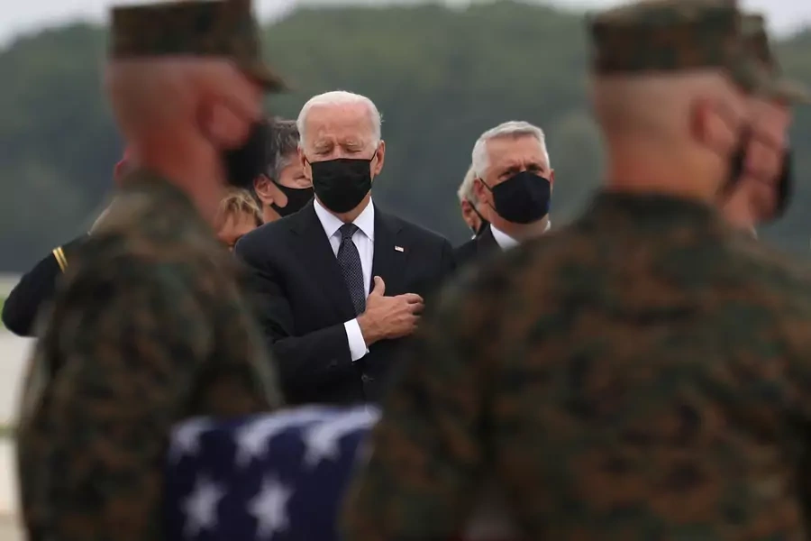 U.S. President Joe Biden salutes during the dignified transfer of the remains of U.S. Military service members who were killed by a suicide bombing at the Hamid Karzai International Airport on August 29, 2021.