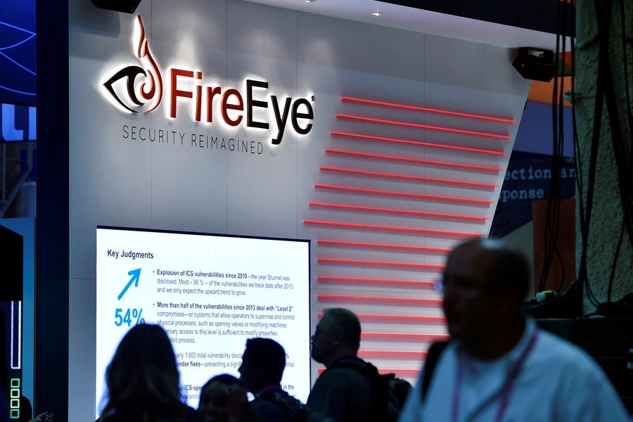 Attendees walk by the FireEye booth during the 2016 Black Hat cyber-security conference in Las Vegas