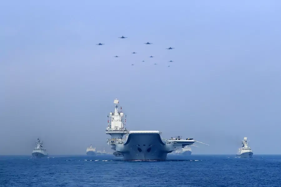 Warships and fighter jets of Chinese People's Liberation Army (PLA) Navy take part in a military display in the South China Sea on April 12, 2018.