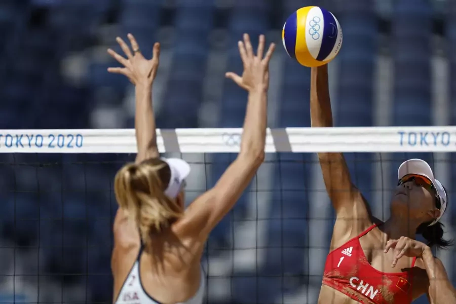 Tokyo 2020 Olympics - Beach Volleyball - Women - Pool B - USA (April/Alix) v China (Xue/Wang X X) - Shiokaze Park, Tokyo, Japan - July 25, 2021. Alix Klineman of the United States with Xue Chen of China in action. 