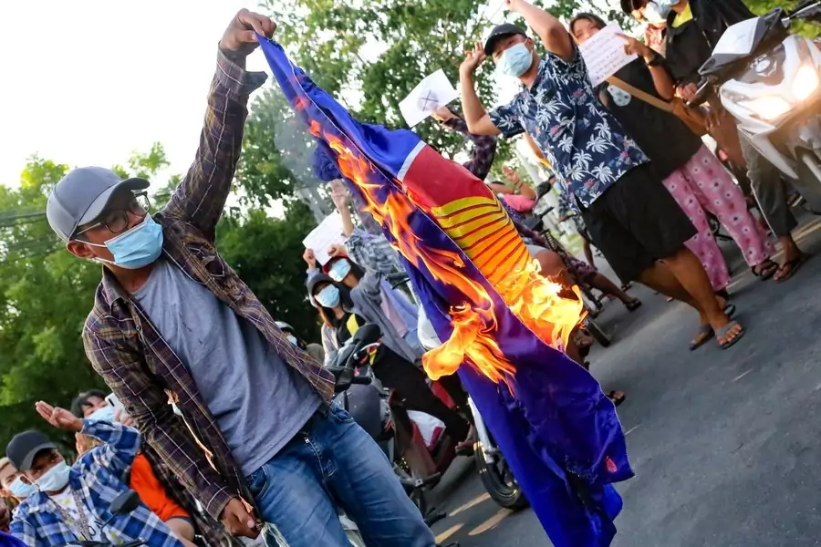 Protesters against Myanmar's junta burn the flag of the Association of Southeast Asian Nations (ASEAN), in Mandalay, Myanmar, on June 5, 2021.