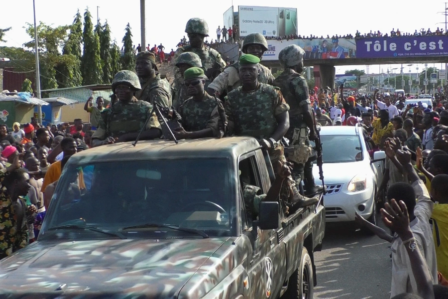 Residents cheer at army soldiers as they celebrate the uprising in Conakry, Guinea on September 5, 2021.