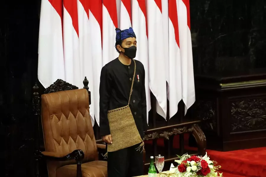 Indonesian President Joko Widodo stands before delivering his State of the Nation Address ahead of the country's Independence Day, at the parliament building in Jakarta, Indonesia, on August 16, 2021.