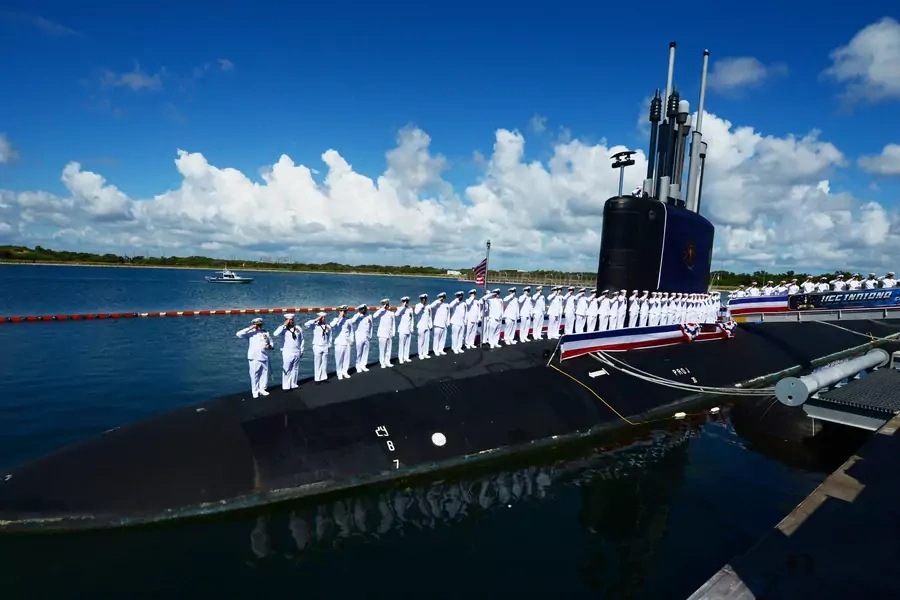 The crew of the Virginia-class attack submarine USS Indiana (SSN 789) salute during the boat's commissioning ceremony.