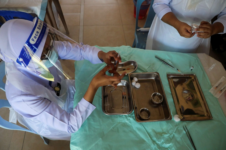 Nurses prepare doses of the Pfizer vaccine against the coronavirus disease (COVID-19) for the secondary school students at a school in Kuala Lumpur, Malaysia, on October 4, 2021.