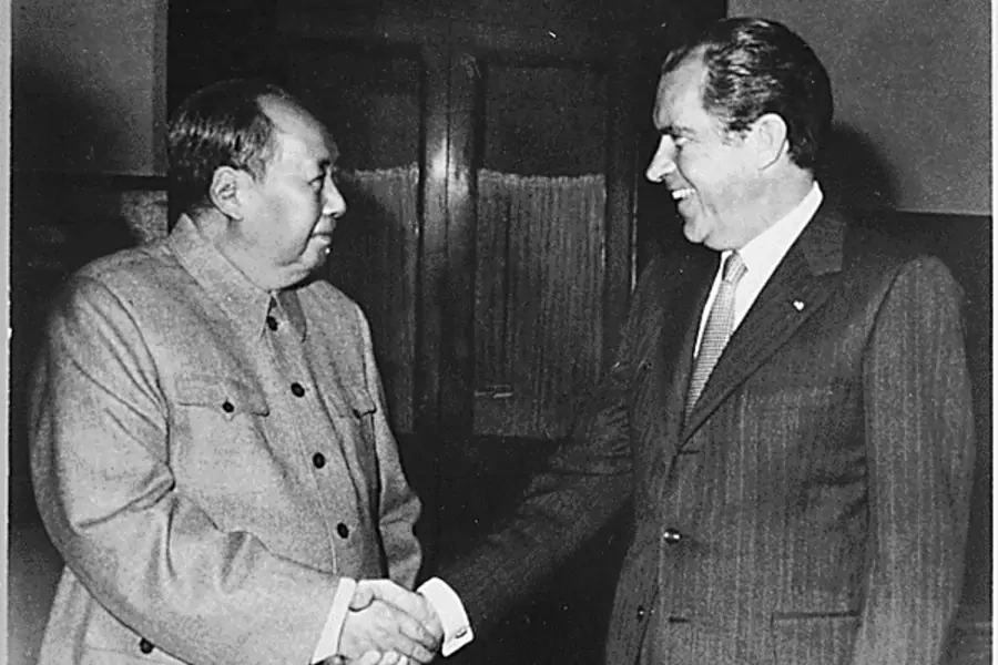 President Richard Nixon and Chairman Mao Zedong shake hands on February 21, 1972.