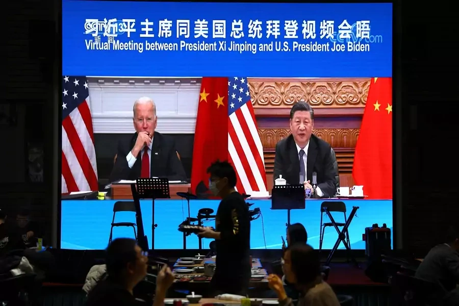 The virtual summit between President Joe Biden and Chinese President Xi Jinping is shown at a restaurant in Beijing on November 16, 2021.