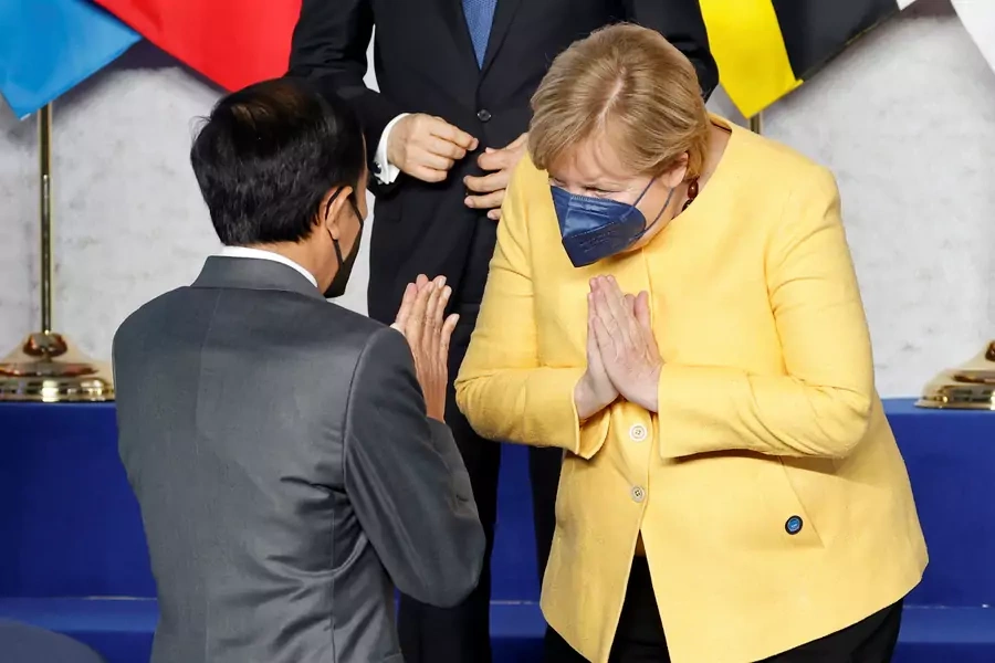 German Chancellor Angela Merkel greets Indonesia's President Joko Widodo at the start of the G20 leaders summit at the convention center La Nuvola in Rome, Italy, on October 30, 2021.