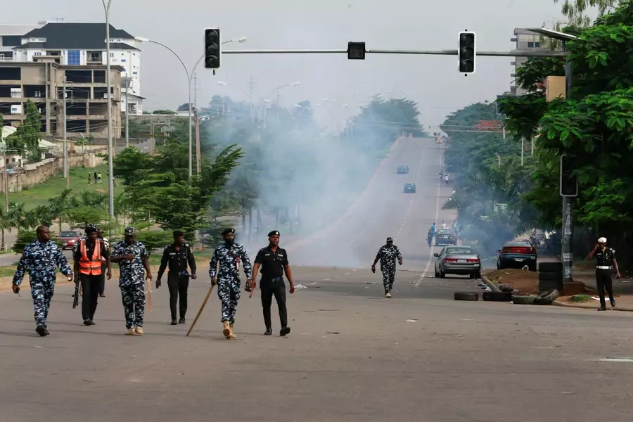 Members of the Nigeria police force walk after chasing protesters away during a June 12 Democracy Day rally in Abuja, Nigeria on June 12, 2021.