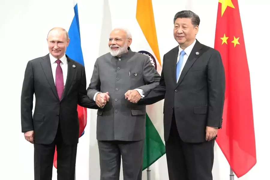 Russia's President Vladimir Putin, India's Prime Minister Narendra Modi and China’s President Xi Jinping pose for a picture during a meeting at the G20 summit in Osaka, Japan on June 28, 2019.