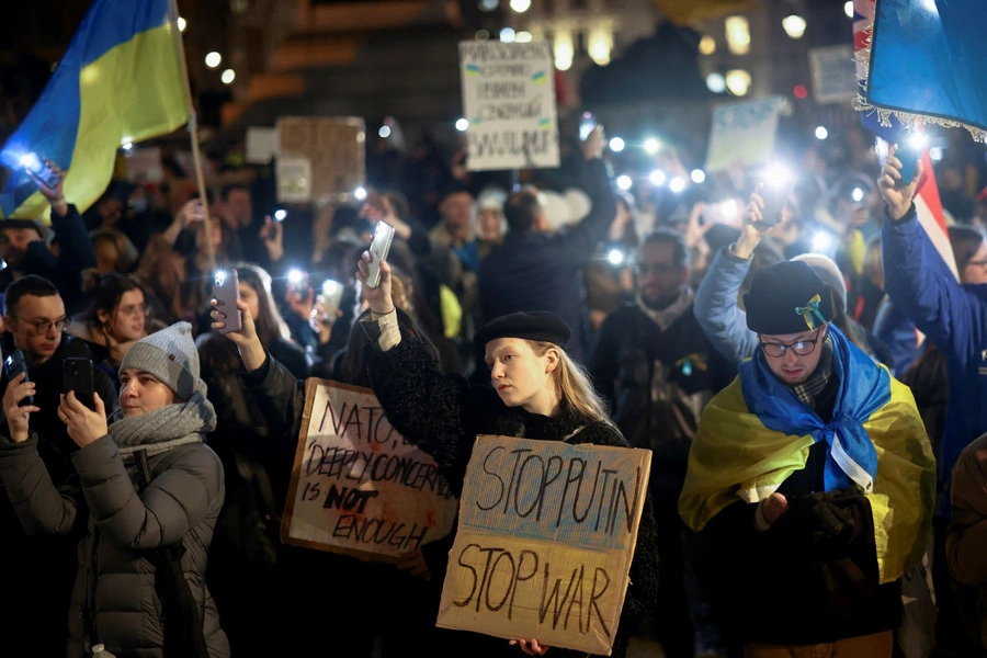 People hold up lit up phones during a protest against Russia's invasion of Ukraine, at Trafalgar Square in London, Britain on March 4, 2022.