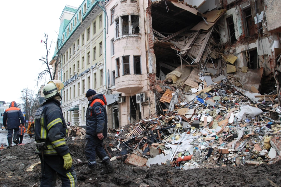 Rescue workers stand near a heavily damaged building, amid Russia's invasion of Ukraine, in Kharkiv, Ukraine on March 14, 2022.