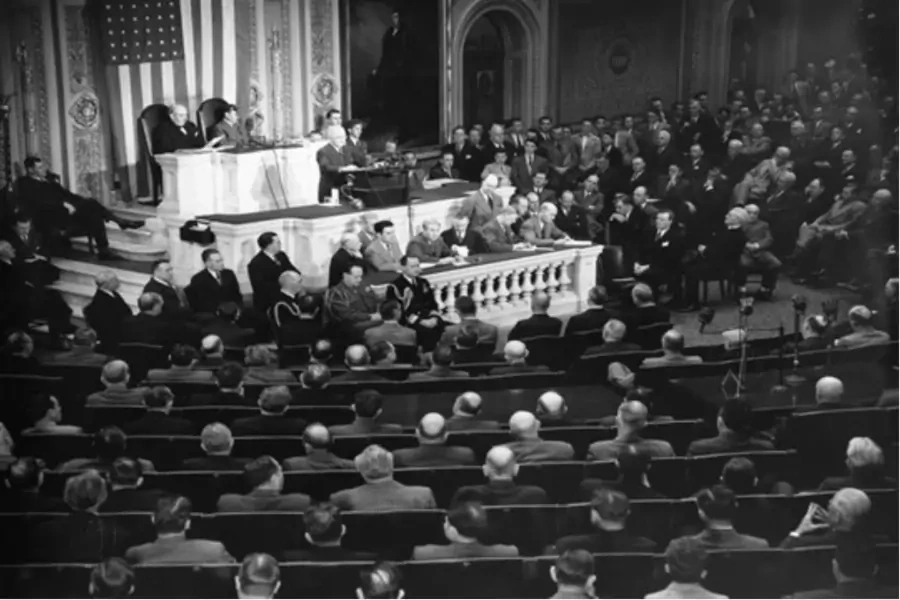 U.S. President Harry S. Truman, standing at podium, addresses a joint session of Congress in the House Chamber in Washington, D.C., March 12, 1947.