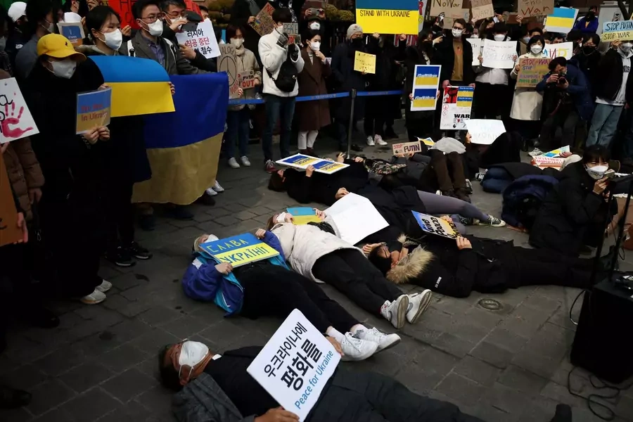 South Korean people lie down on the ground during a protest against the massive military operation by Russia against Ukraine, near the Russian embassy in Seoul, South Korea on February 28, 2022.