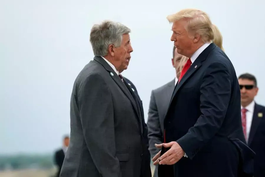 Missouri Governor Mike Parson and President Donald Trump speak at the airport in St. Louis, Missouri in July 2018.