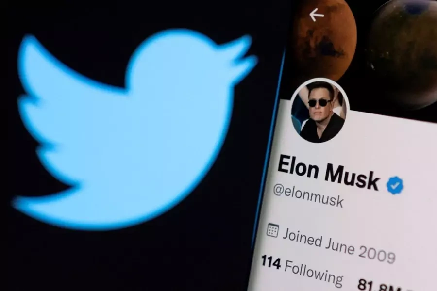 Elon Musk's twitter account is seen on a smartphone in front of the Twitter logo in this photo illustration taken on April 15, 2022. 