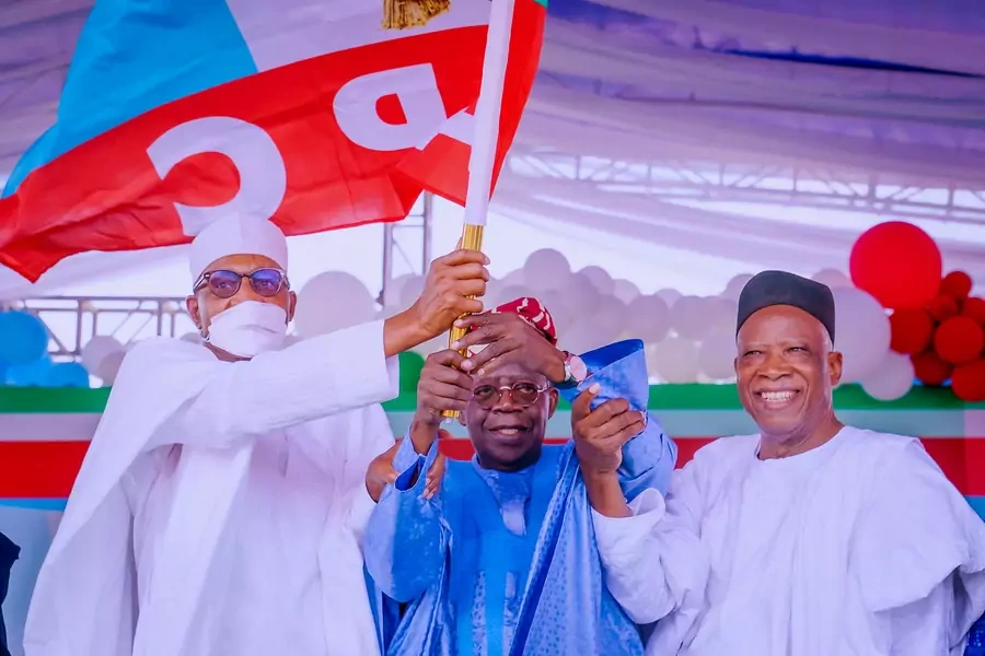 All Progressives Congress (APC) party's new presidential candidate Bola Tinubu holds his party's flag with President Muhammadu Buhari and Abdullahi Adamu, the APC party chairman, during the party convention in Abuja, Nigeria on June 7th, 2022. 