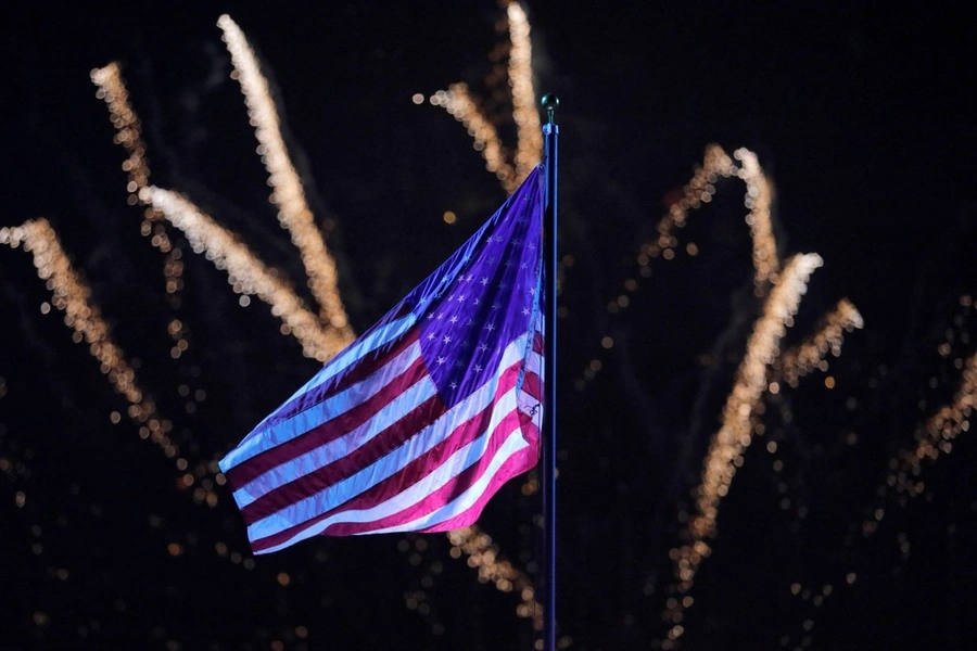 Fireworks explode behind a U.S. flag during New York City’s Independence Day celebrations on July 4, 2021.