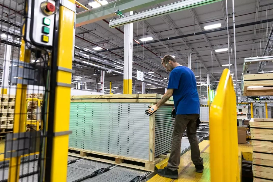 A worker builds a crate at a solar panel manufacturer, First Solar, in Perrysburg, Ohio