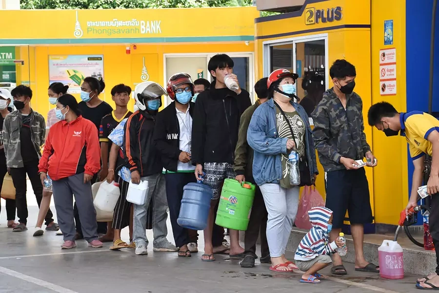 Citizens queue up for fuel at a petrol station in Vientiane, Laos on May 14, 2022. Laos' inflation rate climbed to 12.8 percent in May on a yearly basis, the highest in 18 years, according to the latest report from the Lao Statistics Bureau
