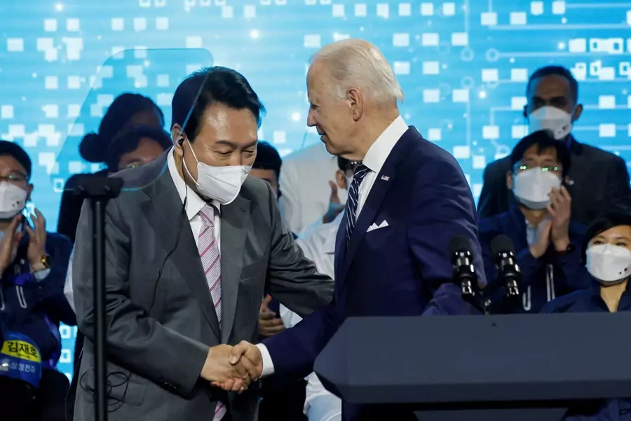 U.S. President Joe Biden shakes hands with South Korean President Yoon Suk-yeol after delivering remarks during a visit to a semiconductor factory at the Samsung Electronics Pyeongtaek Campus in Pyeongtaek, South Korea on May 20, 2022.