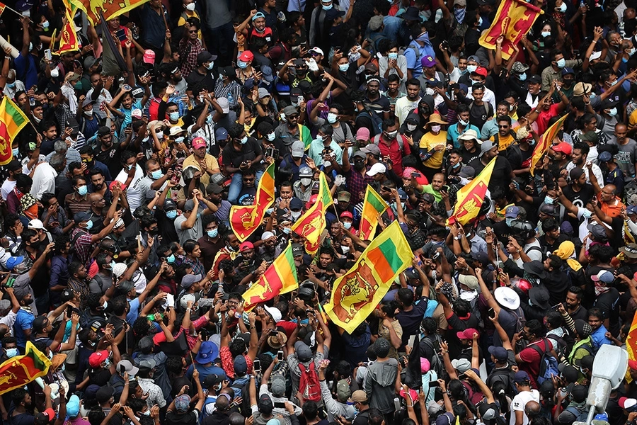 Protesters gather in a street leading to the Sri Lankan President's official residence